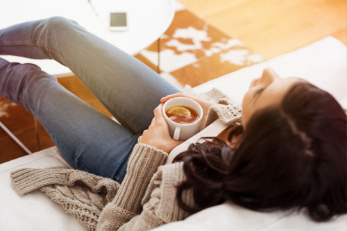 Person relaxing with a cup of tea
